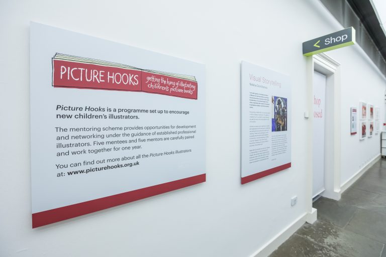 The information panel for the Picture Hooks exhibition featuring a red and white logo.